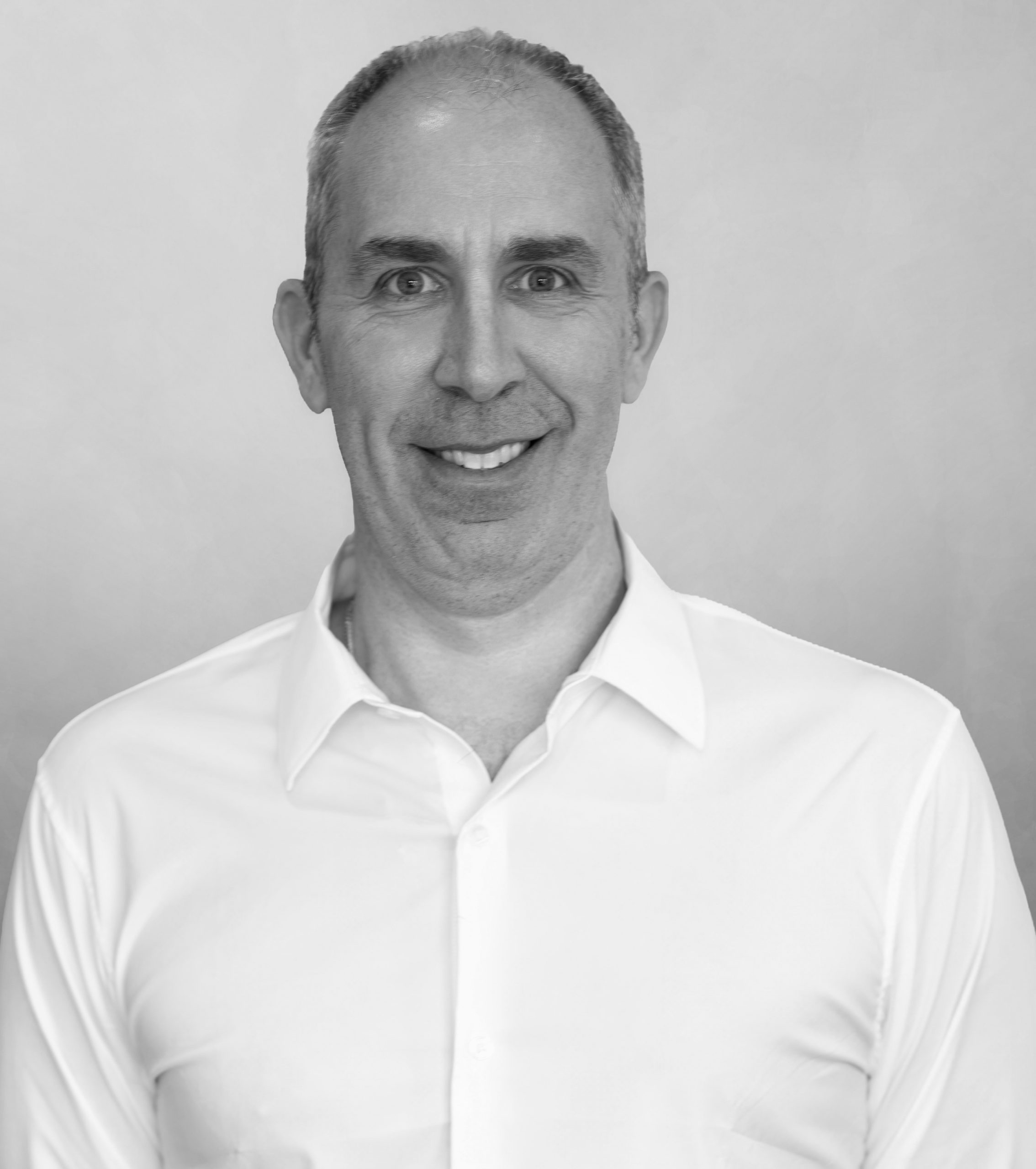 A black and white image of Dr. Jeff Domark, DMD.